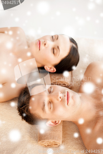 Image of couple in spa salon lying on the massage desks