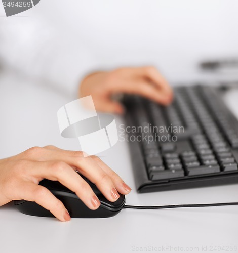 Image of woman hands with keyboard and mouse