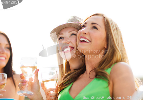 Image of girls with champagne glasses on boat