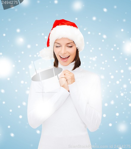 Image of surprised woman in santa helper hat