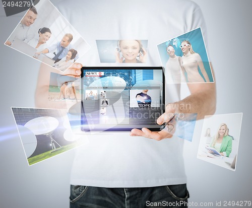 Image of man showing tablet pc with news