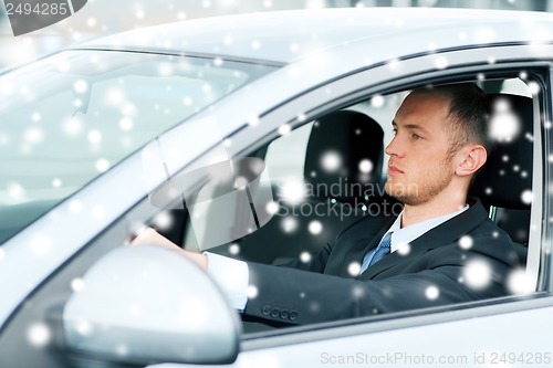 Image of businessman driving a car