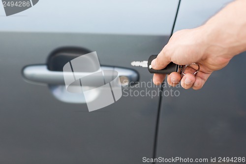 Image of man with car key outside