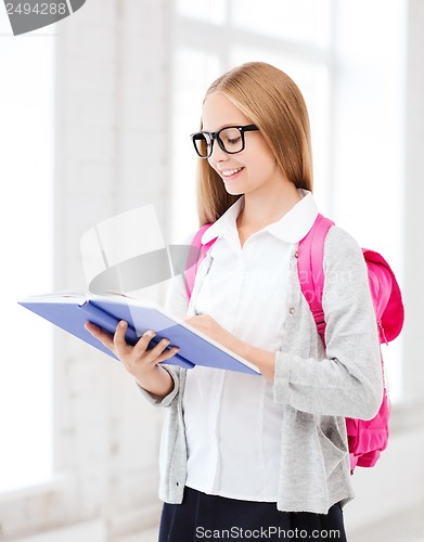 Image of girl reading book at school