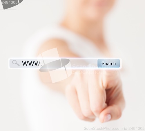 Image of female hand pressing Search button