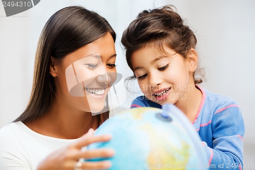 Image of mother and daughter with globe