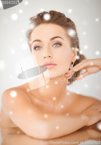 Image of woman wearing shiny diamond earrings