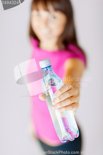 Image of sporty woman with bottle of water