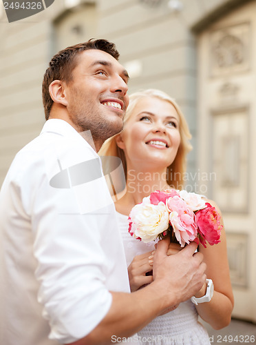Image of couple with flowers in the city