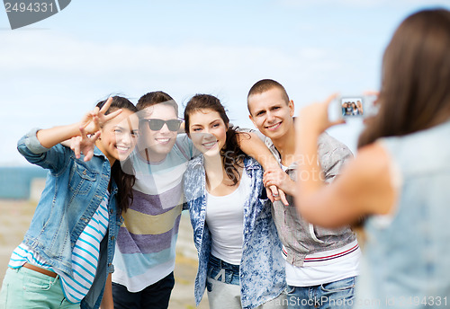 Image of teenagers taking photo outside