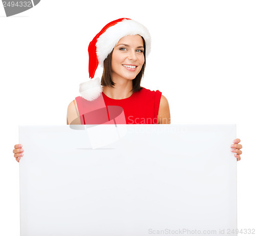 Image of woman in santa helper hat with blank white board