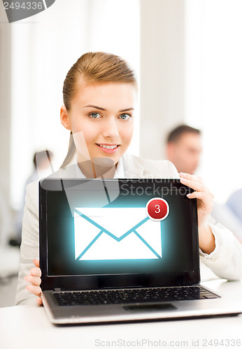 Image of businesswoman holding laptop with email sign