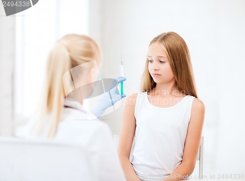 Image of doctor doing vaccine to child in hospital