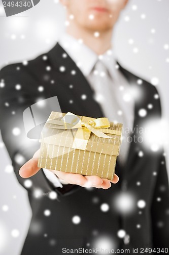 Image of man giving gift box