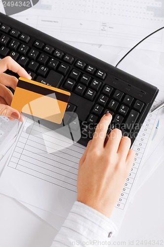 Image of businesswoman with laptop using credit card