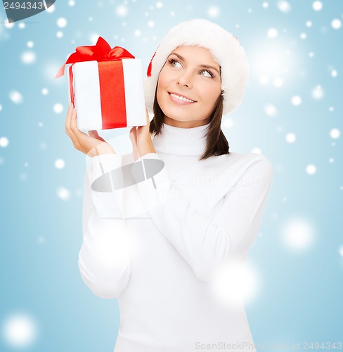 Image of smiling woman in santa helper hat with gift box