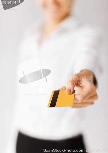 Image of woman showing gold credit card