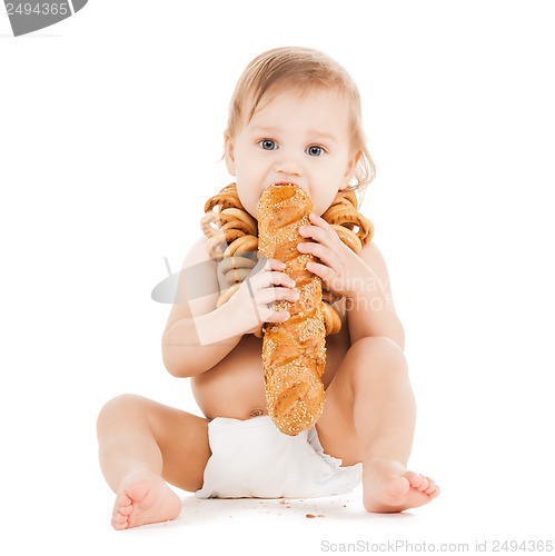 Image of cute todler eating long bread