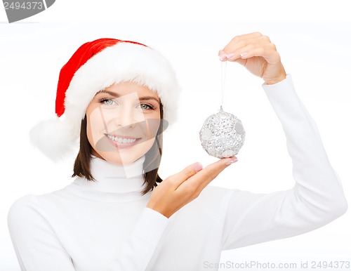 Image of woman in santa helper hat with christmas ball