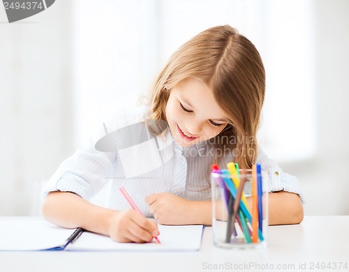 Image of little student girl drawing at school