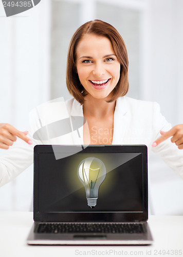 Image of smiling woman with laptop pc