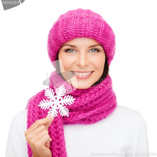 Image of woman in hat and muffler with big snowflake