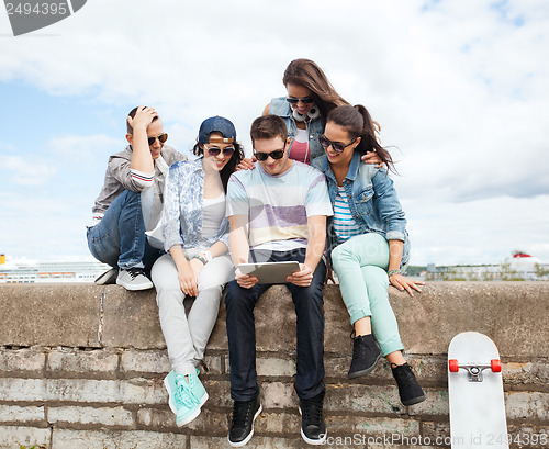 Image of group of teenagers looking at tablet pc
