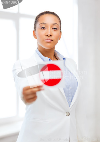 Image of african woman showing stop sign