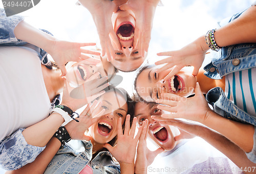 Image of group of teenagers looking down and screaming