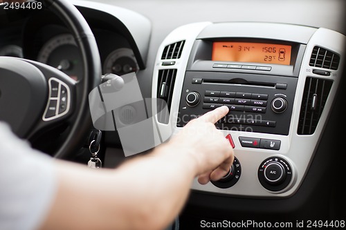 Image of man using car audio stereo system