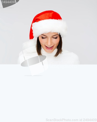 Image of woman in santa helper hat with blank white board