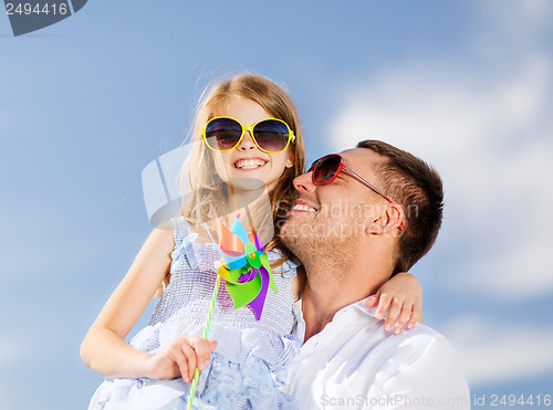 Image of happy father and child in sunglasses over blue sky