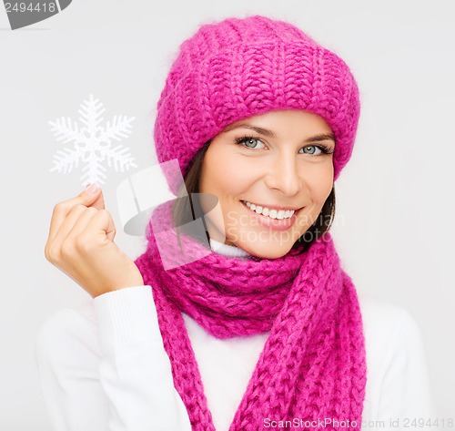 Image of woman in hat and muffler with big snowflake