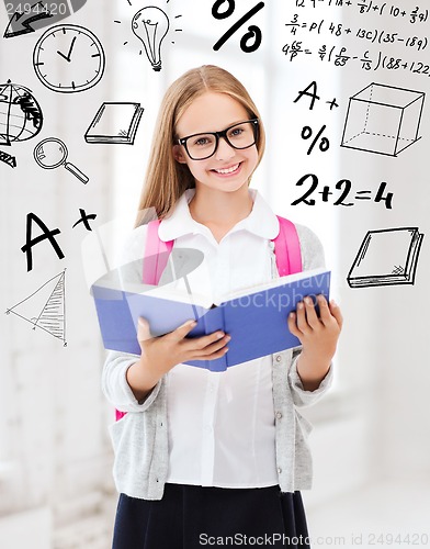 Image of girl reading book at school