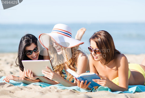 Image of girls with tablet pc on the beach