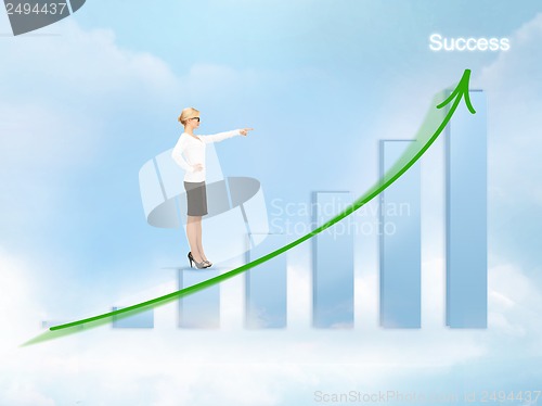 Image of businesswoman pointing at big 3d chart