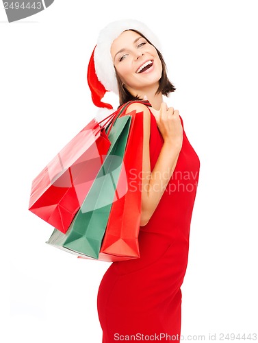 Image of woman in red dress with shopping bags