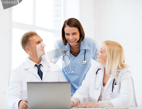 Image of group of doctors looking at tablet pc