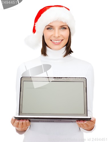 Image of woman in santa helper hat with laptop computer