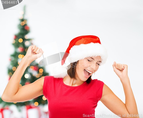 Image of smiling woman in santa helper hat