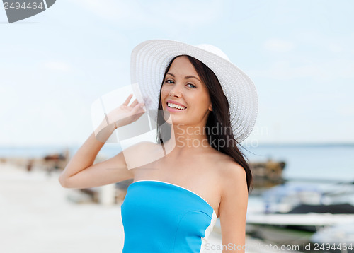Image of girl in hat standing on the beach