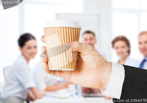 Image of man hand holding take away coffee