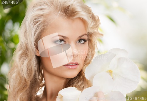 Image of beautiful woman with orchid flower