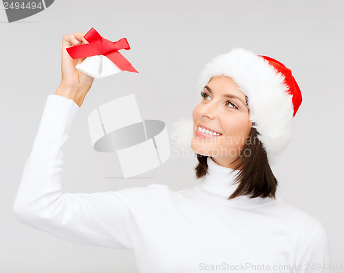 Image of woman in santa helper hat with jingle bells