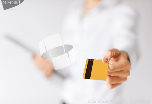 Image of woman showing gold credit card