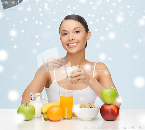 Image of young woman eating healthy breakfast