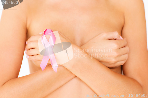 Image of naked woman with breast cancer awareness ribbon