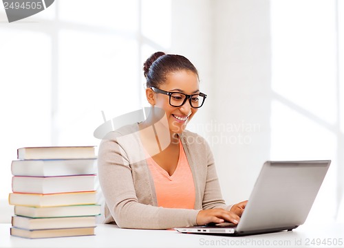 Image of international student girl with laptop at school