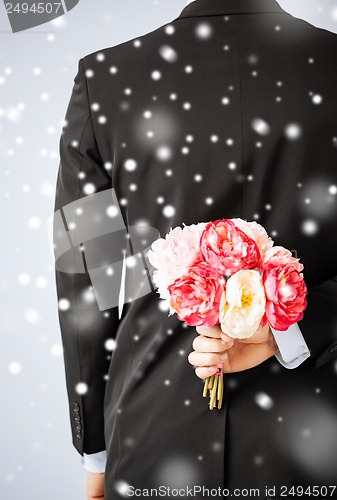 Image of man hiding bouquet of flowers