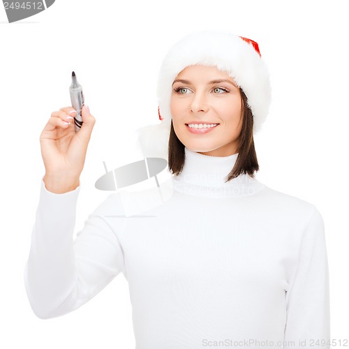 Image of woman in santa helper hat drawing or writing